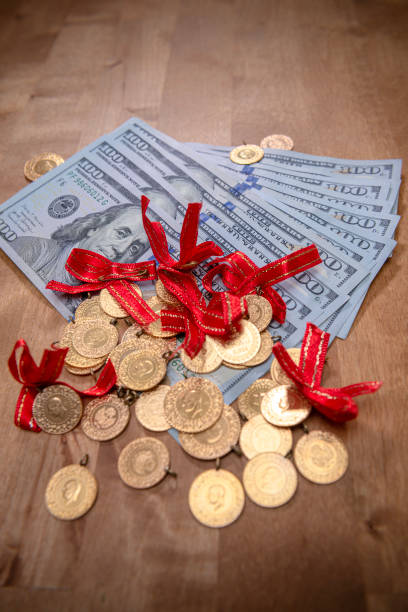 istock Turkish gold coins over US dollar bills. 1450133946