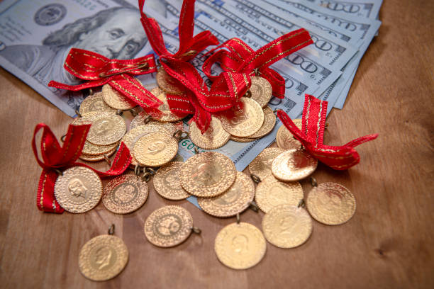 istock Turkish gold coins over US dollar bills. 1450133983