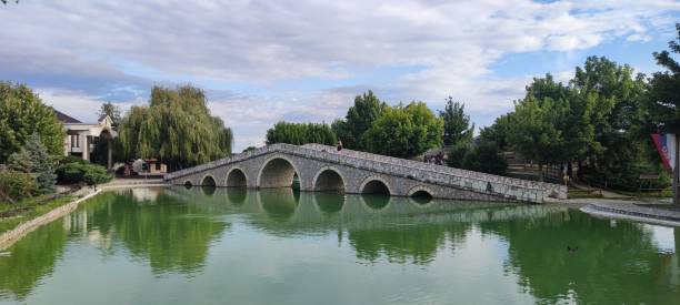 istock Panoramic view of a stone bridge over the lake at daytime 1450149164