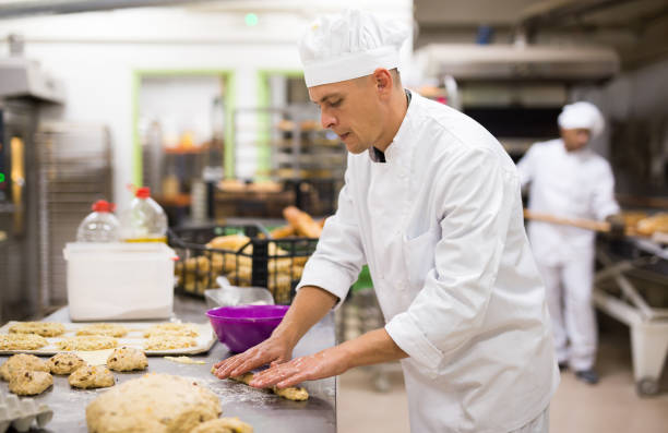 istock Baker makes buns and other sweet pastries from dough 1450150677