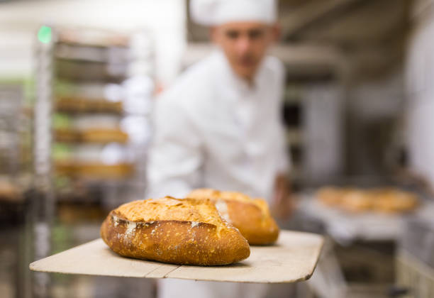 istock chef with ban bread on shovel in bakehouse 1450150724