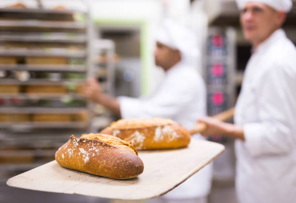 istock Freshly baked bread on peel in bakery 1450150798