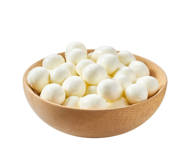istock mini mozzarella cheese balls in a wooden bowl isolated on a white background. 1450150874