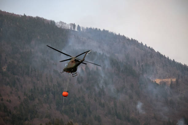 istock Localized wildfire with the helicopter dropping water 1450156822