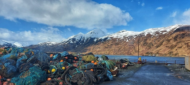 Lot of fishing net and equipment with a view on snowy mountain in Dutch Harbor,Alaska