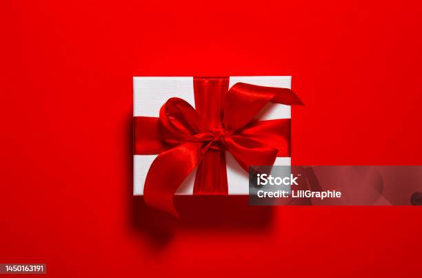 Gift Card Gift Box With Ribbon Bow Red Background Stock Photo - Download Image Now