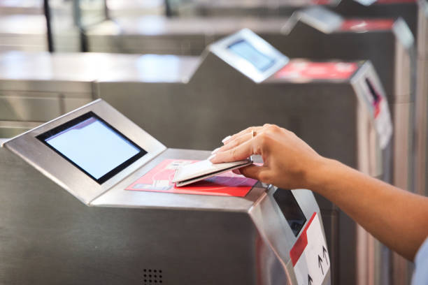istock close-up of an unrecognizable person's hand with an access card entering through the security doors of a public transportation system. 1450164176