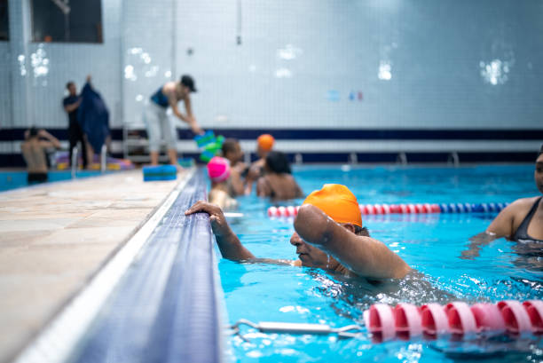 istock Disabled mature man swimming in the swimming pool 1450164781