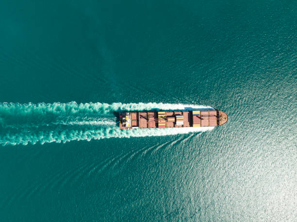 istock Cargo ship in import export and business logistic, Logistic and transportation of International Container Cargo ship in the open sea, Aerial shot from drone. 1450164929