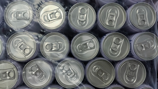 the top side of canned drink cover with plastic to keep it clean in the market