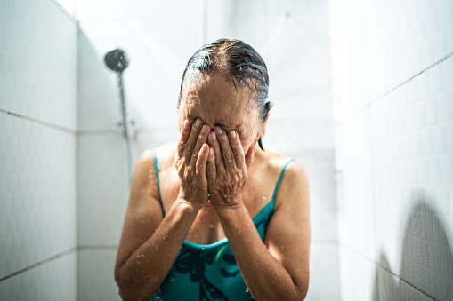 Senior woman taking a shower after swimming class