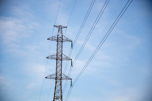 istock Power lines and electric tower with blue sky and clouds on background. 1450174052