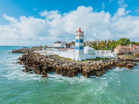 Salvador, Bahia, Brazil - February 10, 2018: view of a typical Brazilian lighthouse named Farol da Barra on the seashore of the city of Salvador in the state of Bahia, Brazil on a sunny summer day.
