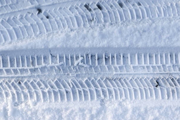 istock Close up view tire tracks at the surface of fresh fallen snow. 1450177003