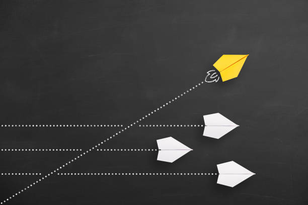 istock Change concepts with yellow paper airplane leading among white 1450177488
