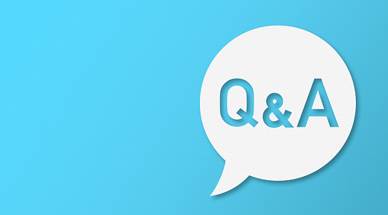 Question and Answer Speech Bubbles with Copy Space On Blue Cardboard Background