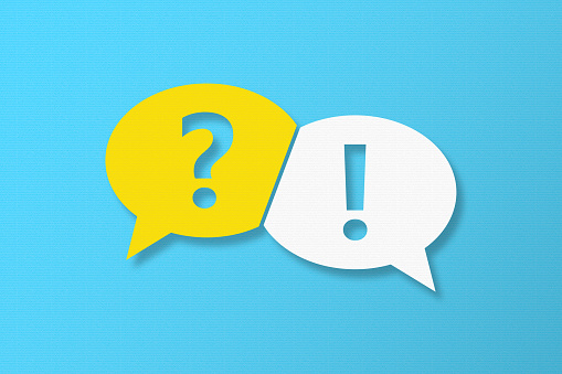 Question and Answer Speech Bubbles with Copy Space On Blue Cardboard Background