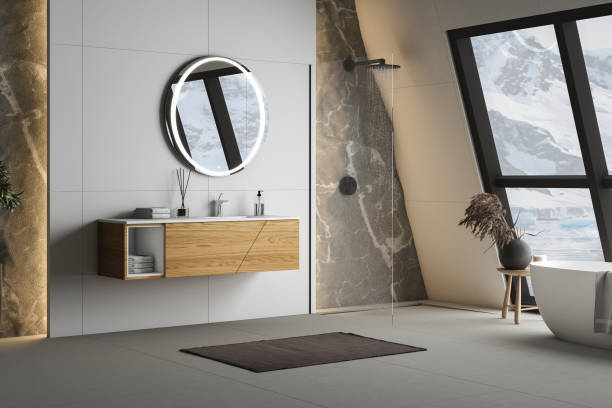 istock Modern bathroom interior with concrete floor, white oval bathtub and white basin, shower, plant and snowy mountain view from windows. Minimalist bathroom with modern furniture. 3D rendering 1450182355