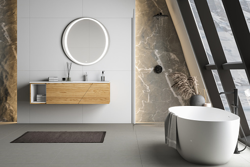 Modern bathroom interior with concrete floor, white oval bathtub and white basin, shower, plant and snowy mountain view from windows. Minimalist bathroom with modern furniture. 3D rendering