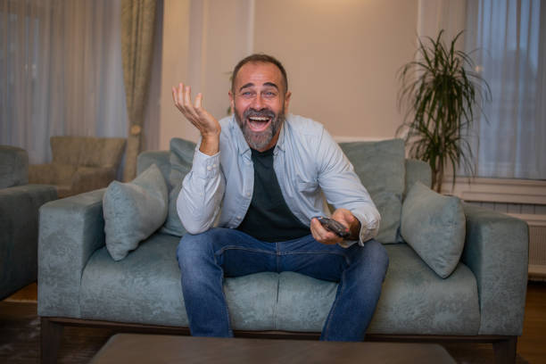 istock Man watching TV in the room 1450184557