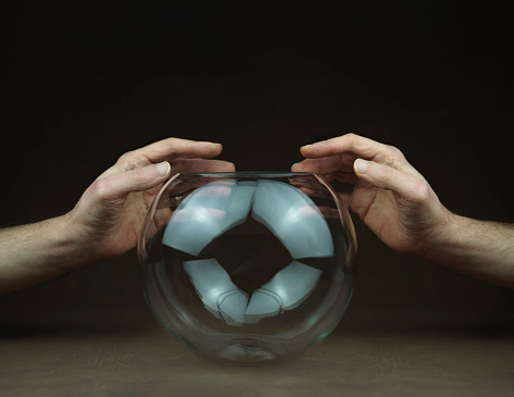 hands over transparent glass ball. High quality photo