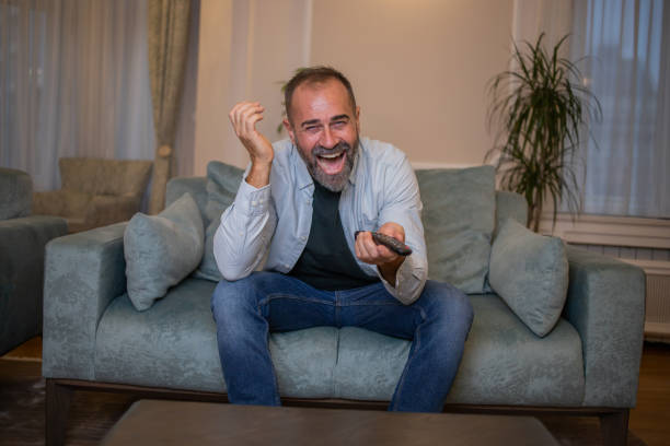 istock Man watching TV in the room 1450184599