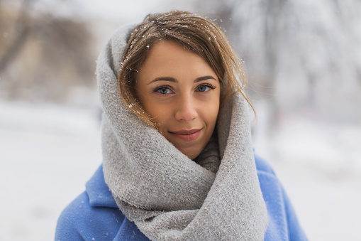 Woman in scarf outdoors in winter.