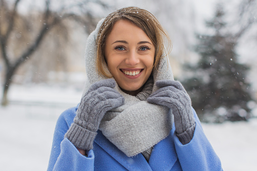 Woman in blue coat outdoors in winter.