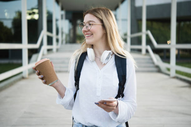 istock Portrait of a beautiful student using smartphone and enjoying coffee 1450191719