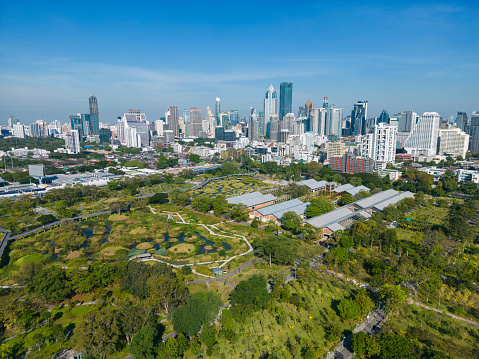 Aerial view city green forest public park with modern office building Benjakitti Park Bangkok Thailand