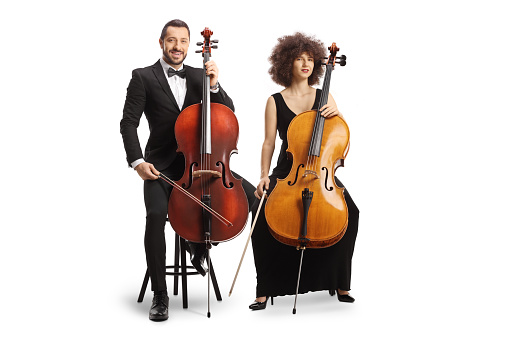 Male and female cellists from a music orchestra