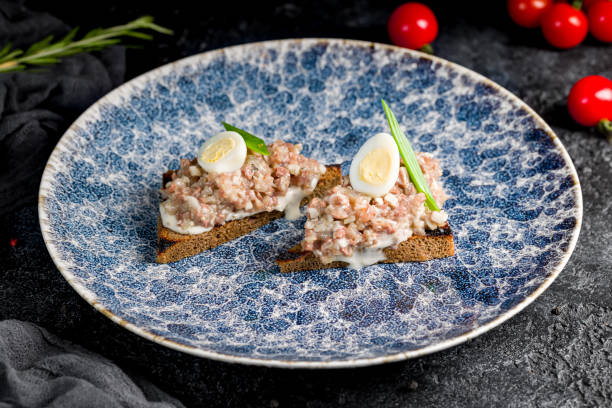 istock forshmak of herring with black bread on dark table 1450206219