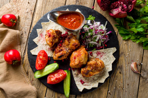 istock chicken kebab on black plate on wooden table top view 1450206232