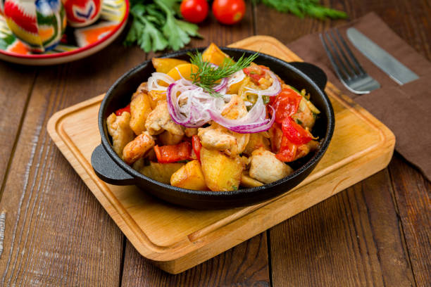 istock Fried Chicken, potatoes and vegetables on old wooden table 1450207017