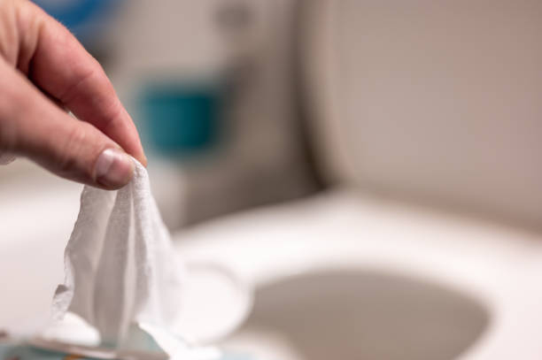 istock Disposable wipes being flushed down a toilet where they can cause clogging and problems with wastewater treatment. 1450207394