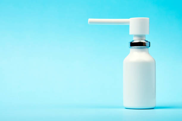 istock Nasal spray bottle on blue background with copy space 1450213840