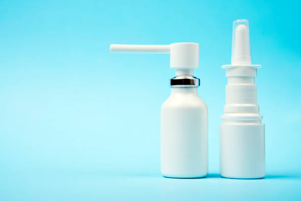 istock Nasal spray bottle on blue background with copy space 1450213842