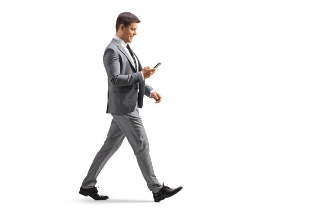 istock Full length profile shot of a professional man using a smartphone and walking 1450213882