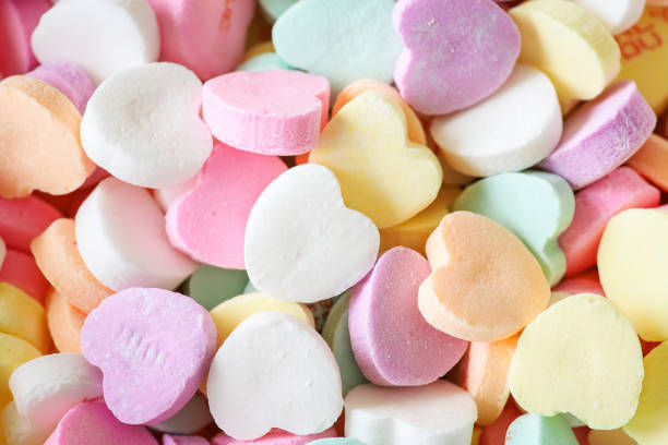 Close up of a colorful pile of pastel candy hearts for Valentine's Day.