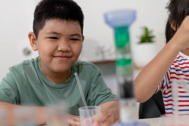 istock Asian Children enthusiastically watch chemistry experiments. 1450215882