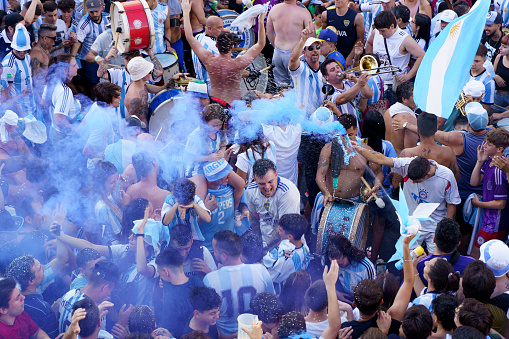 Buenos Aires, Argentina - December 18, 2022: Happy Argentine football fans celebrate winning a final football match at the Qatar 2022 FIFA World Cup. High quality photo