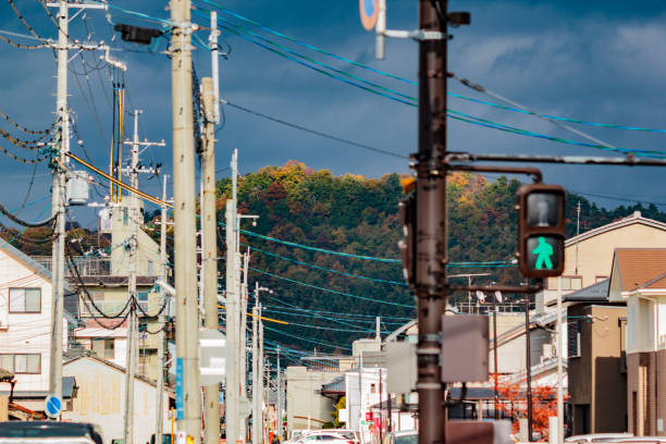 istock Sunlit hilltop framed by dark clouds and a busy street 1450219063