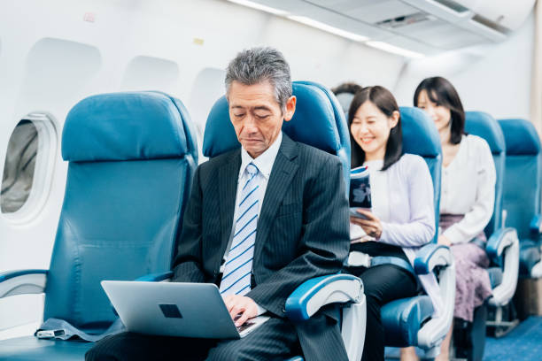 istock Middle-aged businessman on a business trip by plane 1450220337