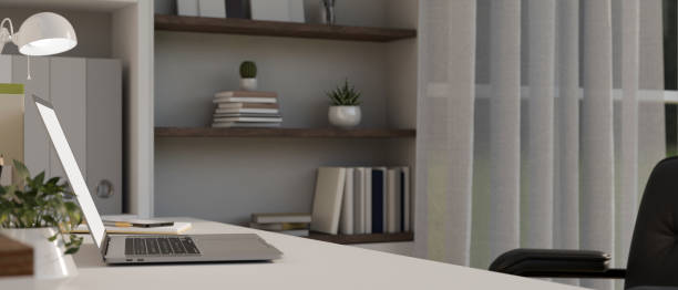 istock side view, Modern home working table with laptop and decor on table, built-in shelves with decor 1450221102