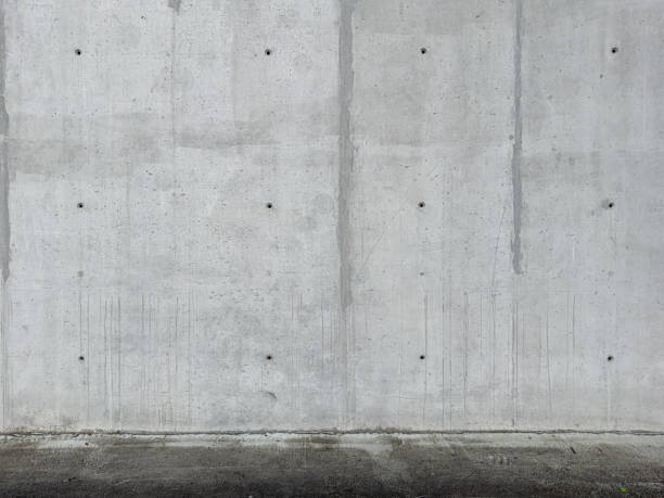 istock Gray concrete wall and asphalt flooring 1450222668