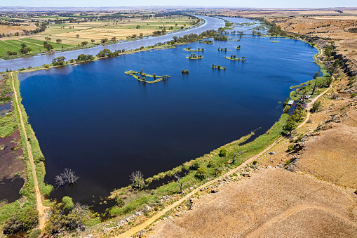 Aerial view Murray River and flooded  Paiwalla Wetlands  from above Sunnyside Lookout in South Australia.  Levee in foreground, cliffs and agricultural lands in background