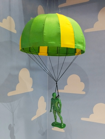 Toy soldier in a parachute on the sky