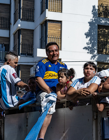 La Plata, Buenos Aires, Argentina - December 18, 2022: Fans on a truck celebretes Argentina winning the 2022 FIFA World Cup in Qatar.