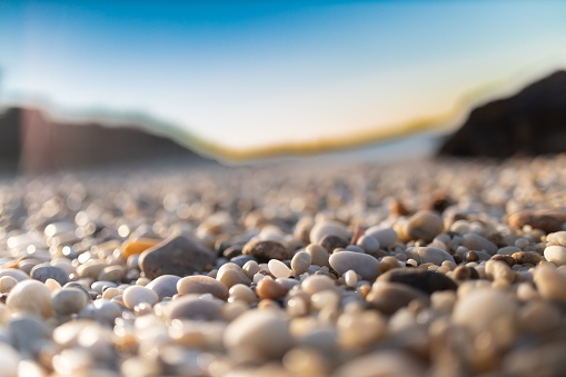 A shallow focus shot of pebbles on the beach
