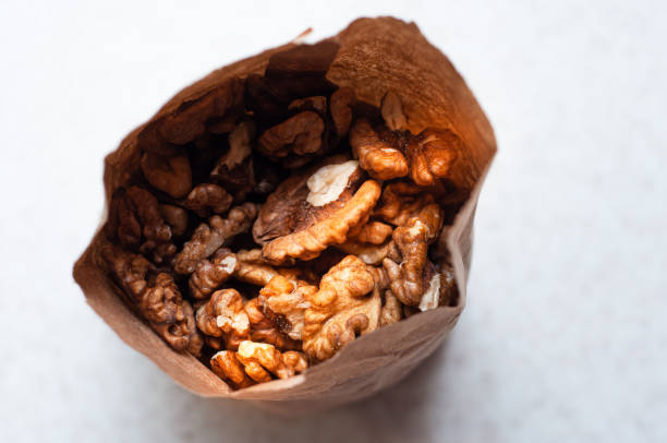 istock The peeled walnut kernels are packaged by weight in an eclogical paper bag. 1450232723